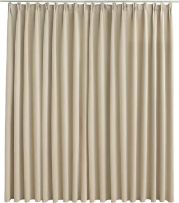 A full-frame shot of a beige curtain hanging from a rod.