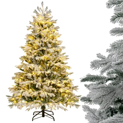A decorated artificial Christmas tree with lights and snow, next to a close-up of another artificial Christmas tree branch.