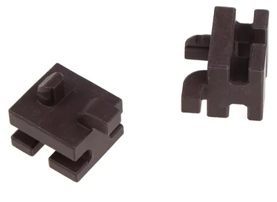 Two dark brown plastic components are shown against a white background. The component on the left is a square-like piece with a protruding peg on top and interlocking slots on the bottom. The component on the right is an L-shaped piece with a slot on top a