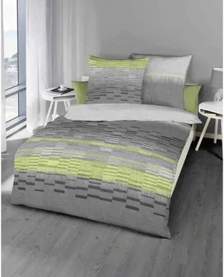 A bed with bedding in a modern bedroom setting.