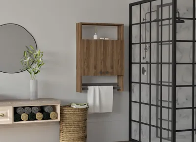 A bathroom scene featuring a wooden cabinet with a towel rack, a mirror, and a shower enclosure.