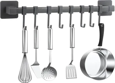 A kitchen utensil rack with various kitchen tools hanging from it.
