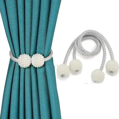 A teal curtain is held back by a magnetic curtain tie-back with two pearl-like balls. A second, similar tie-back is shown separately on the right.