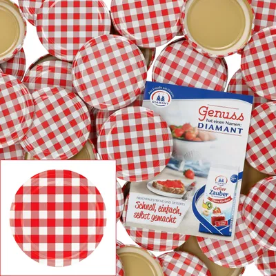 A collection of red and white checkered jar lids, with a small booklet featuring jam and strawberries.