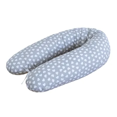 A C-shaped pillow with a heart pattern on a white background.