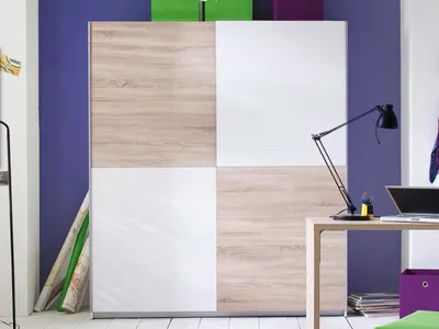 A wardrobe with sliding doors in a room setting.