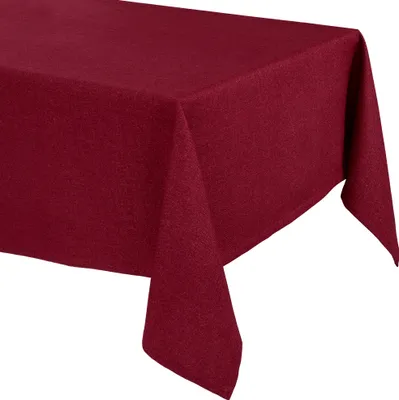 A close-up view of a burgundy tablecloth draped over a table.