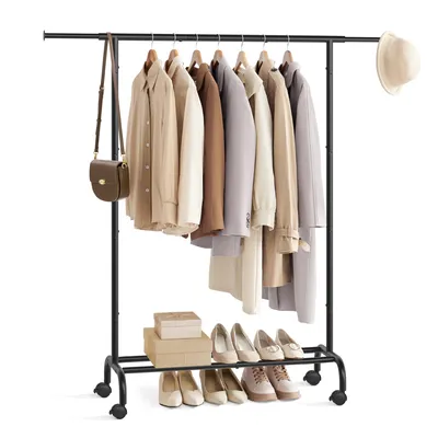 A clothing rack with clothes and shoes on display, with a handbag and hat as accessories.