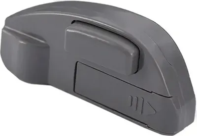 A gray electronic device with a button and some engraved markings.