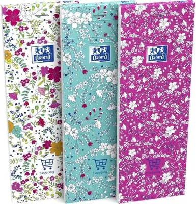Three floral patterned notebooks standing upright.
