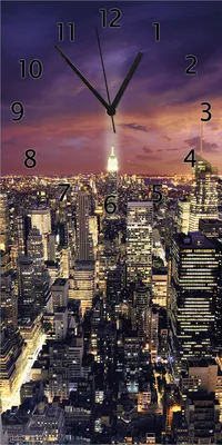 Produktbild von Wallario Design Wanduhr New York bei Nacht - Panoramablick über die Stadt aus Echtglas, Größe 30 x 60 cm