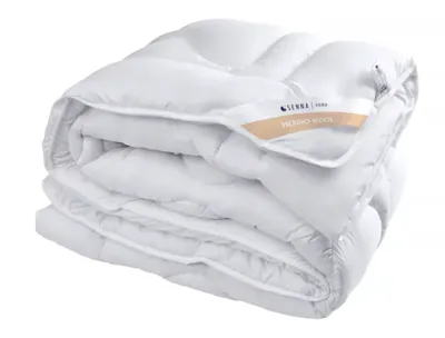 A folded white duvet is shown against a white background.
