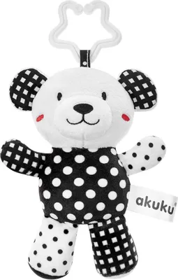 A black and white teddy bear toy with a star-shaped clip for hanging.