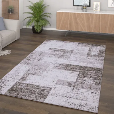 A living room scene with a rug, sofa, and cabinet.