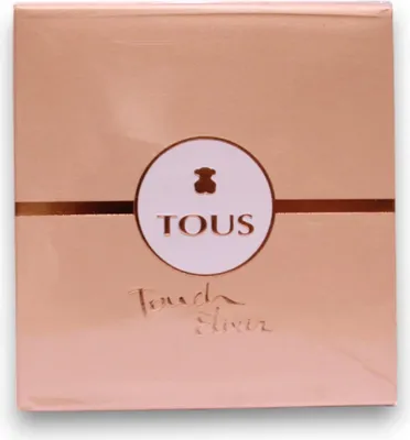 A rose gold box with the TOUS logo and product name.