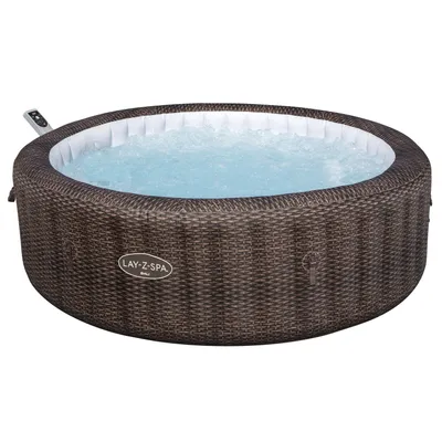 An inflatable hot tub with a rattan-like exterior filled with bubbling water.