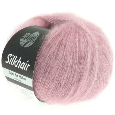 A ball of pink mohair yarn with a black label.