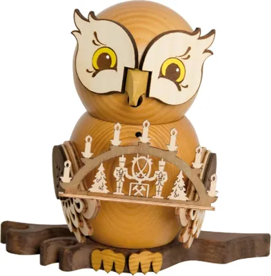 A wooden owl figurine with a candle holder arch.