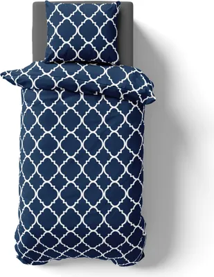 A top-down view of a bedding set on a gray surface.