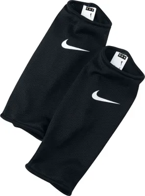 A pair of black Nike shin guards with white Nike logos.