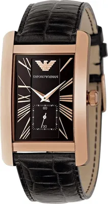 A close-up studio shot of a rectangular watch with a black dial and rose gold casing.