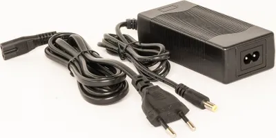 A black power adapter with two cables on a white background.