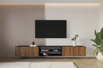 A modern living room with a wall-mounted TV cabinet and a large television.
