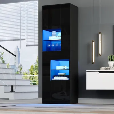 A modern black vitrine with blue LED lighting is showcased in a stylish living room setting, next to a staircase and a wall-mounted cabinet.