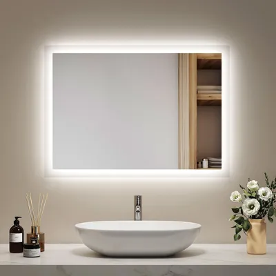 A modern bathroom vanity with a sink and a lighted mirror.