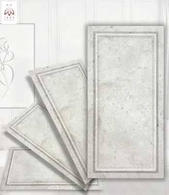 Several decorative wall panels are arranged in a fanned-out display against a white, vertically paneled wall. A framed piece of art with a line drawing is visible on the left.