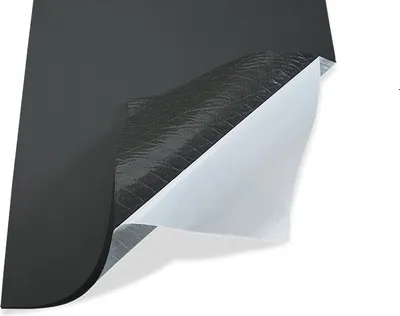 A close-up view of a piece of black insulation material with a silver backing, partially peeled back to reveal a white protective layer.
