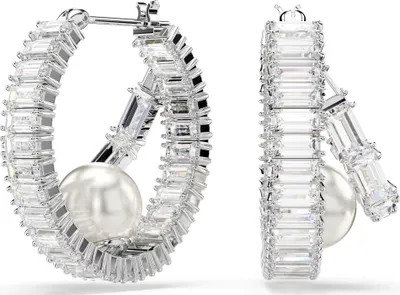 A pair of Swarovski earrings with pearls and crystals.