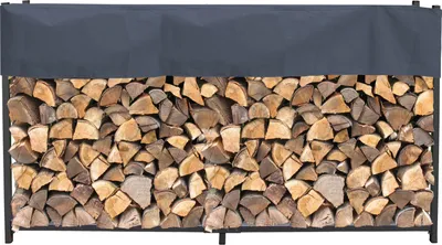 A firewood rack filled with logs, covered by a dark gray protective tarp.