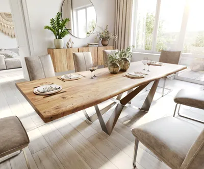 A dining room with a live-edge wooden table and chairs, set for a meal.