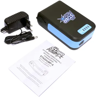 A power bank, charging adapter, and instruction manual are laid out on a white surface.