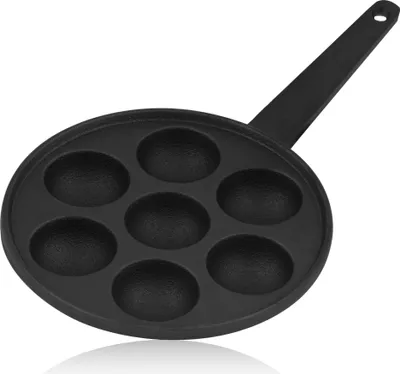A black cast iron pan with seven circular indentations for making poffertjes or other small baked goods.