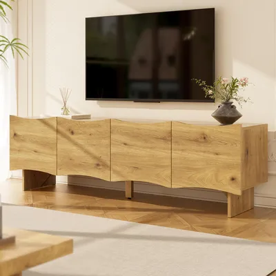 A modern living room with a TV mounted on the wall above a wooden TV stand.