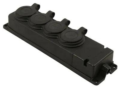 A black electrical multi-socket outlet with four covered sockets and a cable entry point, shown from a diagonal angle on a white background.