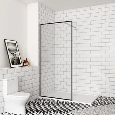 A modern bathroom with a toilet, shower enclosure, and tiled walls and floor.