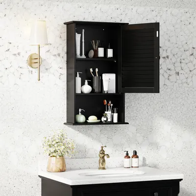 A black bathroom cabinet with its door open, displaying various toiletries and accessories, mounted on a speckled white wall above a sink.