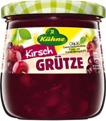 A jar of Kühne Kirsch Grütze with cherries visible inside and on the label.
