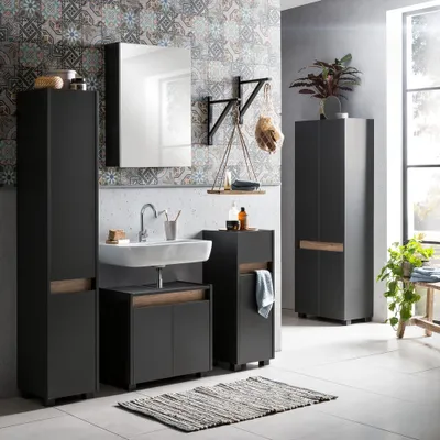 A modern bathroom with a vanity, sink, mirror, and storage cabinets.