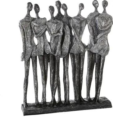 A sculpture of seven abstract female figures standing together.