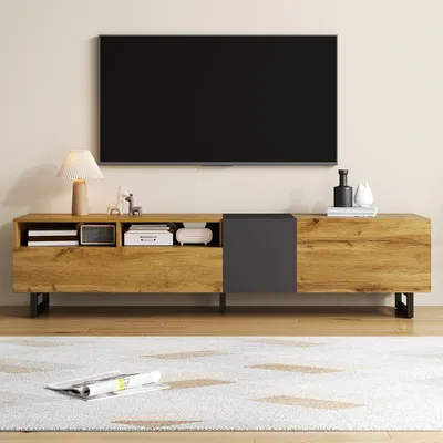 A TV stand with a television mounted above it, in a living room setting.