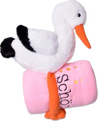 A plush stork toy is wrapped around a pink blanket with yellow stars and text.