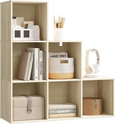 A modular shelving unit with various items placed inside its compartments.