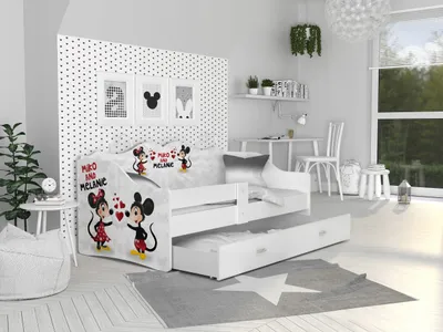 A child's bedroom with a white bed featuring Mickey and Minnie Mouse characters, a pull-out drawer, and a desk area.