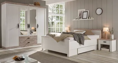 A bedroom scene featuring a bed, wardrobe, and nightstand.