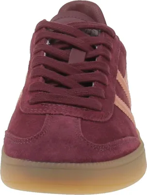 A close-up front view of a burgundy sneaker with pink stripes and a gum sole.