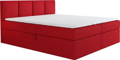 A red boxspring bed with a white mattress and a tufted headboard, shown from a side-angle.